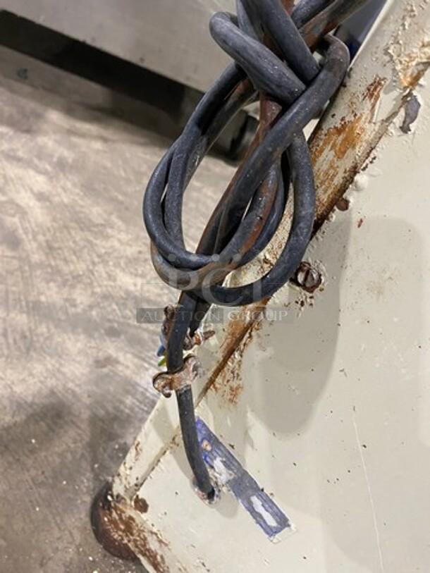 Benier commercial dough divider/rounder with visible wear, rust, and 220V power cable; heavy-duty floor model.