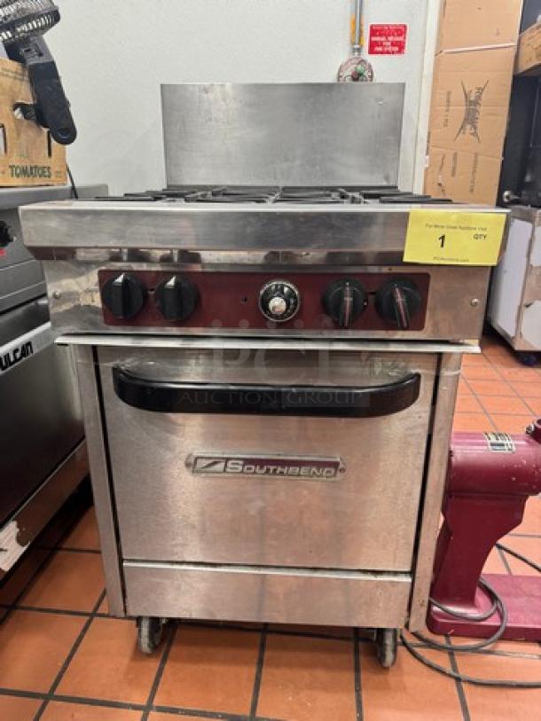 SOUTHBEND X424E Commercial NG 4-burner range on casters, featuring control knobs, oven below, Southbend logo on door.