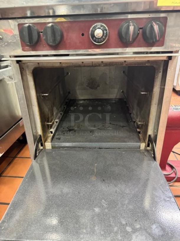 SOUTHBEND X424E commercial NG 4 burner range with open oven, controls visible, on casters, used condition.