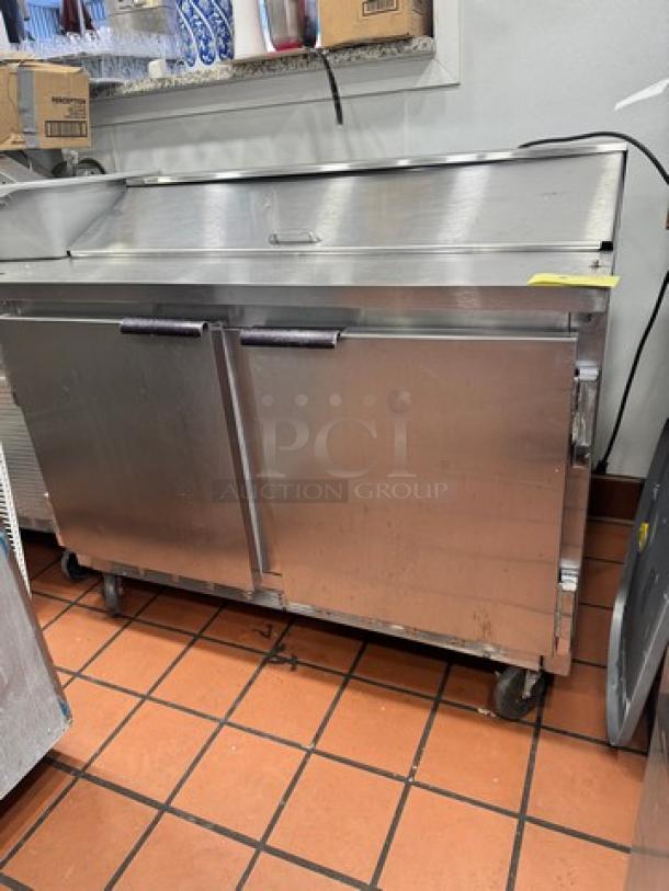 Beverage-Air SUR48-12 two-door prep table on casters, stainless steel, gently used, ideal for commercial kitchens.