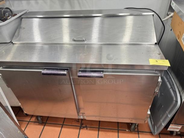 Beverage-Air SUR48-12 two-door prep table on casters, stainless steel, used condition, features slide-top access and storage.