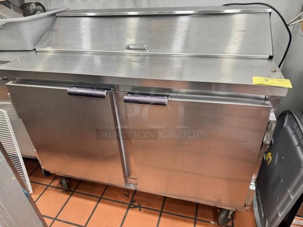 Beverage-Air SUR48-12 two-door prep table on casters, stainless steel, used condition, with top cover and handles.