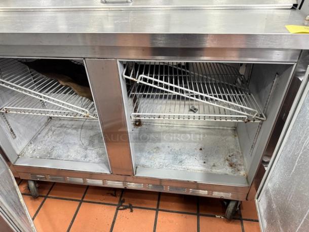 Beverage-Air SUR48-12 prep table on casters, stainless steel, two-door, wire shelves, used condition with wear.