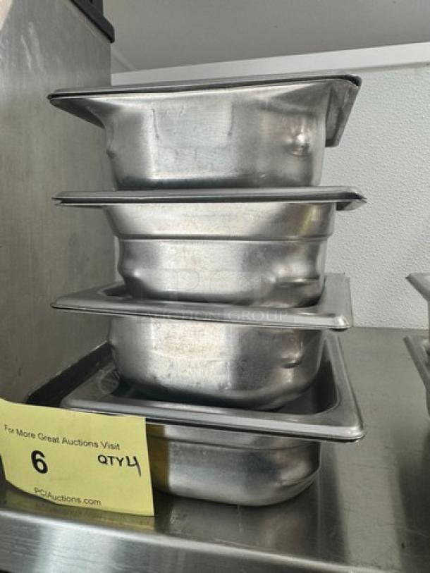 1/6 size stainless steel food pan set with lids, showing stacking condition. Yellow tag displays auction details and quantity 4.