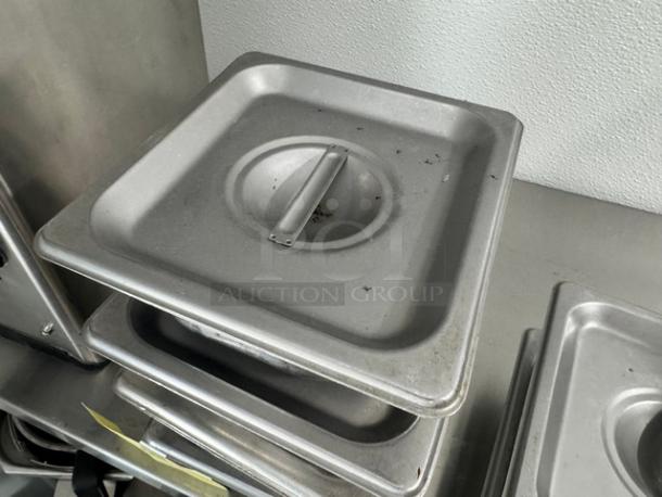 1/6 size stainless steel food pan with lid, used condition, stackable design, ideal for commercial kitchen use.