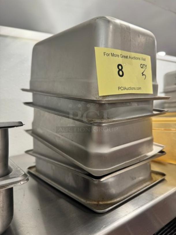 Stack of 1/3 stainless steel food pans, used, showing minor wear. Auction tag indicates lot 8, quantity 5.