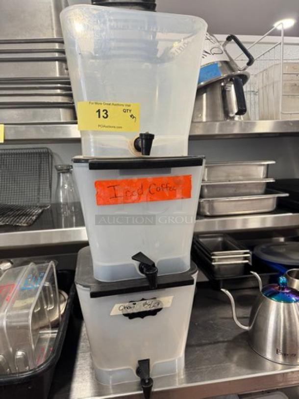 Lot of 3 three-gallon beverage dispensers with spouts; one lid missing. Labels read "Iced Coffee" and "Choco."