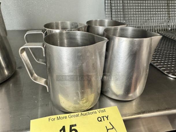 Lot of four 10oz stainless steel milk frothing pitchers, featuring sturdy handles. Good condition. All one money.