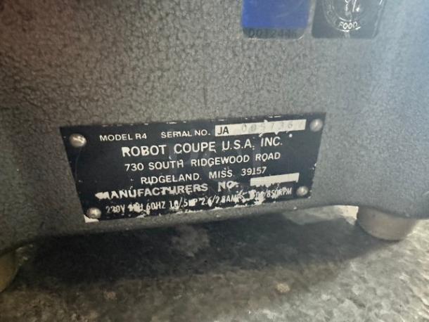 Robot Coupe R4 commercial food processor, model and serial labels, 220V, used condition, sturdy base, manufacturer info visible.