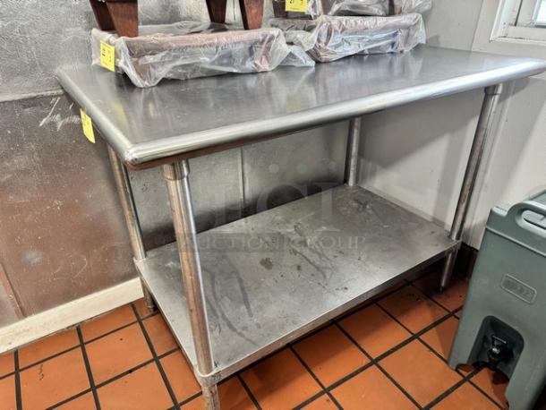 47" stainless steel work table with undershelf, used condition, minor surface wear, sturdy design, ideal for kitchen use.