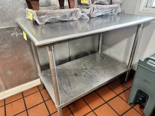 47" stainless steel work table with undershelf, used condition, minor surface wear, sturdy design, ideal for kitchen use.