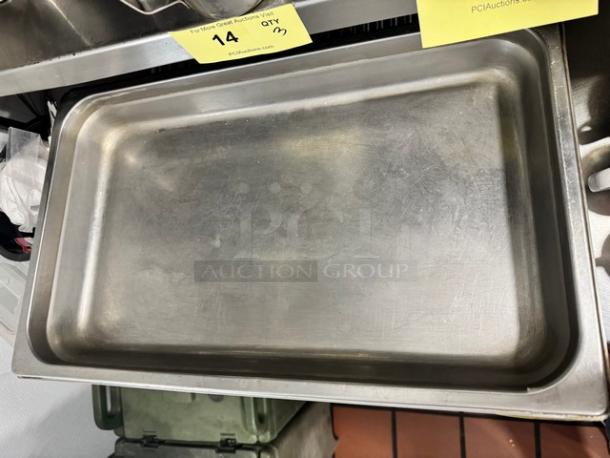 Full-size 2 1/2" deep stainless steel food pan, lightly used, visible surface scratches, ideal for commercial kitchen use.