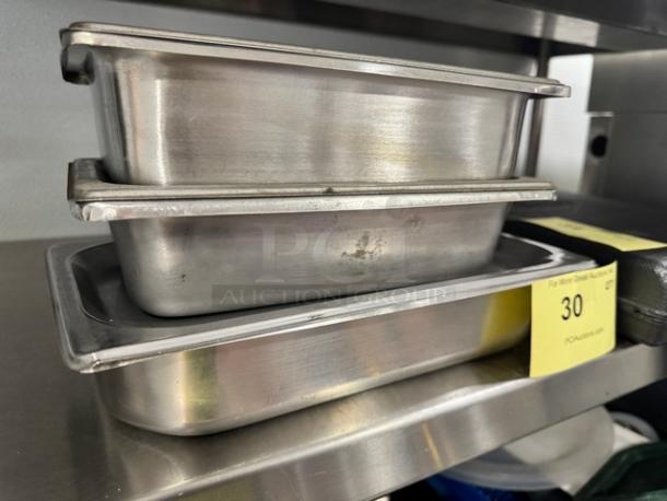 Stainless steel stackable pans with lids, model BIDX3, showing minor wear. Auction tag indicates lot 30.