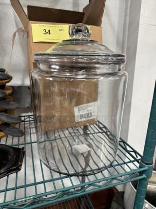 Brand new 2-gallon glass jar with lid, clear design, pristine condition. Ideal for storage, measures approximately 12 inches tall.