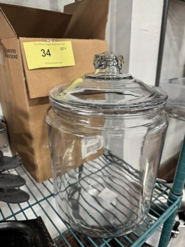 Brand new 2-gallon clear glass jar with a decorative lid. Sturdy construction, ideal for storage or display.