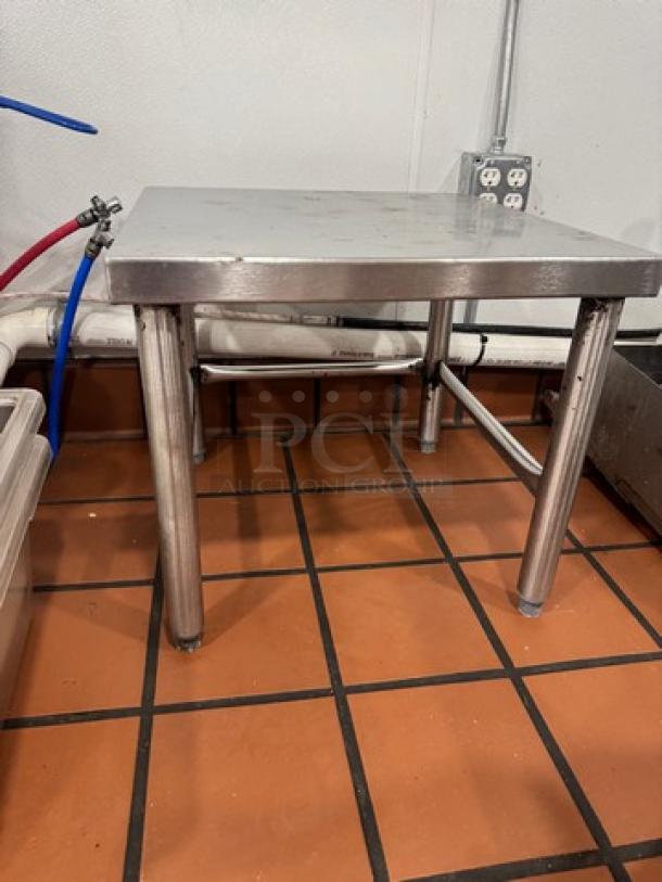 20" stainless steel stand with sturdy legs, clean surface, suitable for kitchen or industrial use, visible screw detailing.