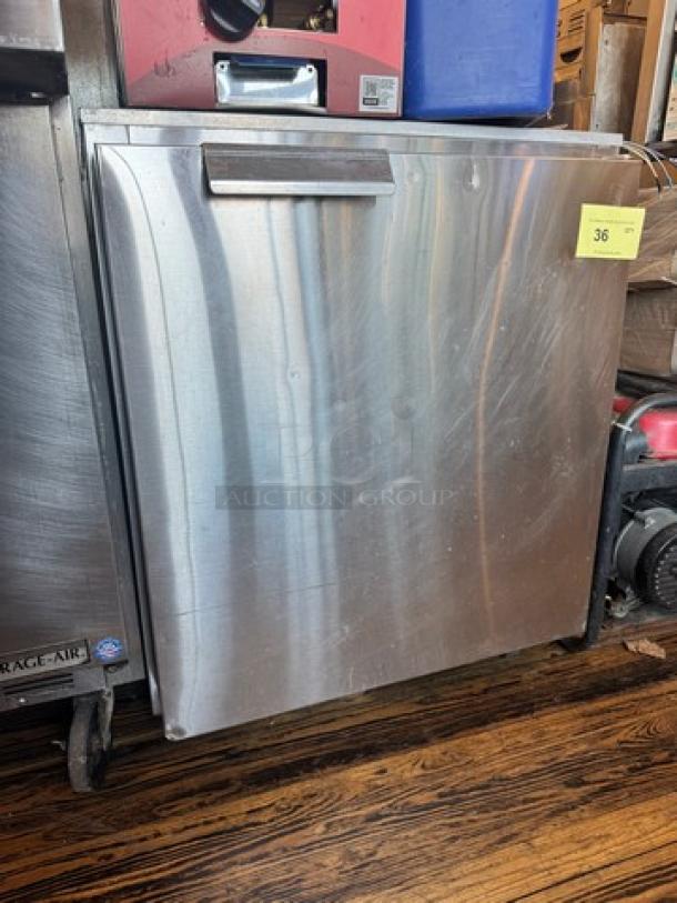Delfield 406-CA Undercounter Refrigerator, stainless steel, 115V, visible wear, auction tag "36" attached.