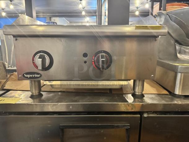 Superior GGM-24 24" natural gas griddle, stainless steel, dual control knobs, like new condition, brand label visible.