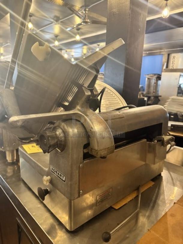 Hobart 1712 Commercial Meat Slicer, 115V, stainless steel, used condition. Features precision blade and sturdy design.