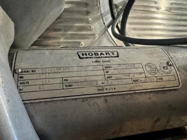 Hobart 1712 commercial meat slicer, 115V, serial 56-805-369, made in USA. Features a visible label detailing specs.