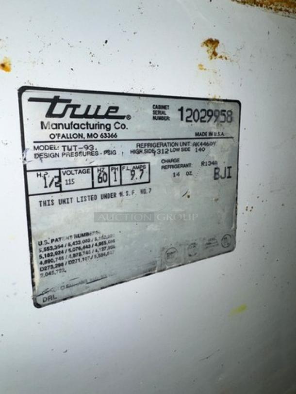 True TWT-93 3-door worktop refrigerator label, model info, voltage 115V, serial 12029958, on casters, made in USA.