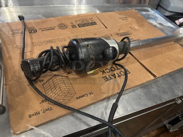 Waring Commercial Handheld Blender, black handle, metal shaft, good condition, coiled power cord visible.