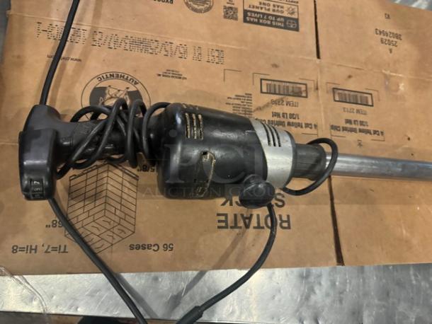 Waring Commercial Blender with black handle and metal shaft, coiled cord, signs of wear, vintage model.