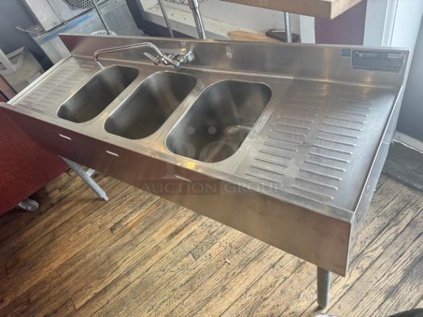 EAGLE stainless steel underbar sink with 3 compartments, faucet, and 2 drainboards. Durable, used condition.