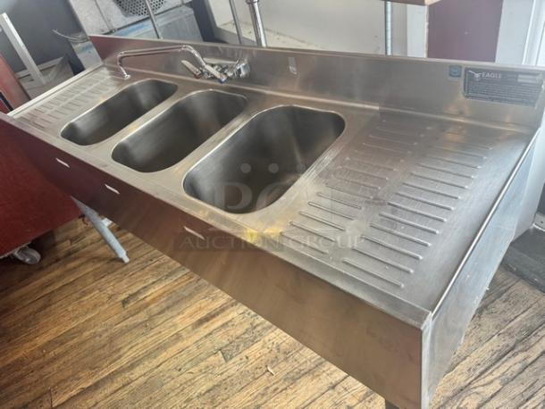 EAGLE stainless steel 3-compartment underbar sink with faucet, 2 drainboards. Good condition, sleek design, ideal for bar use.