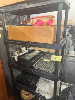 5-tier plastic storage shelving unit, black, in used condition. Contents not included. Auction tag visible on third shelf.