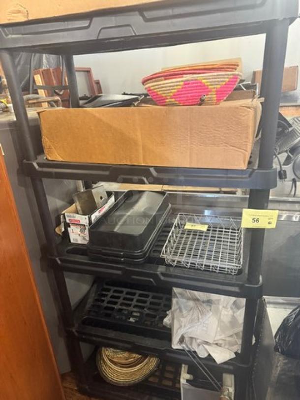 5-tier plastic storage shelving unit, black; good condition. Contents not included; ideal for organizing spaces.