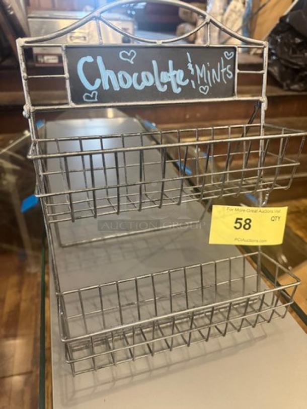 Metal countertop display holder with two wire baskets. Chalkboard label reads "Chocolate Mints." Item tag "58" from PCAuctions.com.