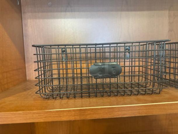 Lot of 2 metal wire hanging baskets in good condition, black finish, ideal for organizing, includes wall mounting hardware.
