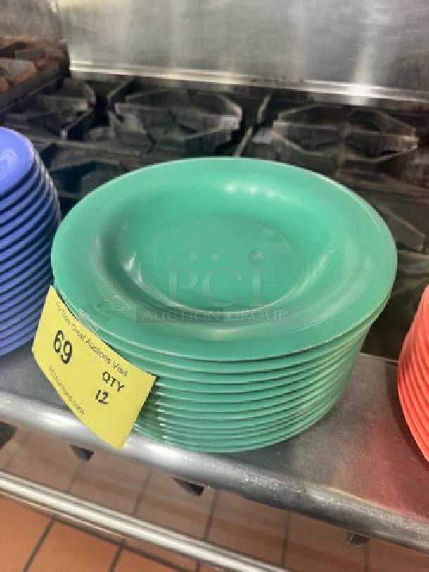 Stack of green melamine plates, model BIDX12, shown with quantity tag indicating 12 units. In good condition.