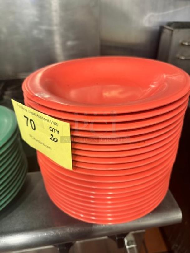 Stack of red melamine plates, model BIDX20, in good condition. Quantity of 20 with auction lot tag attached.