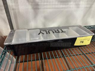 Black True condiment tray with clear lid, five compartments. Label marked "76" for auction. Appears in good condition.