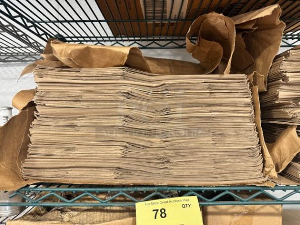 Stack of Duro 1/6 paper sack bags on a shelf, brown color, neatly stacked, yellow auction tag showing "78".