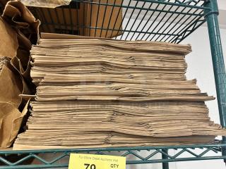 Stack of Duro 1/6 paper sack bags on a metal shelf. Bags are unused and neatly stacked. Quantity note visible below.