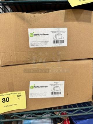 Two boxes labeled "RW Restaurantware" containing rectangle black plastic tabletop condiment caddy-napkin dispensers, model BIDX5.