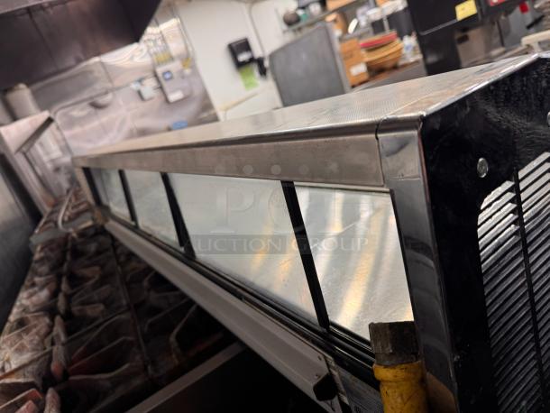 Turbo air SAK-70K Sakura Sushi Display Merchandiser in kitchen setting, features glass front, metal frame, 120V, good condition.