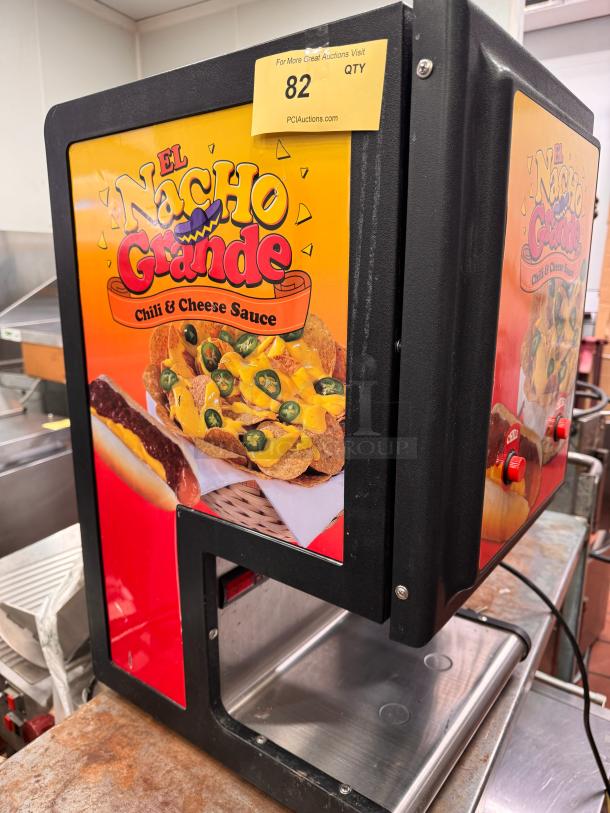 Gold metal Dual Chili Cheese Dispenser 5301, 120V, vibrant El Nacho Grande graphics, good condition with auction tag "82".