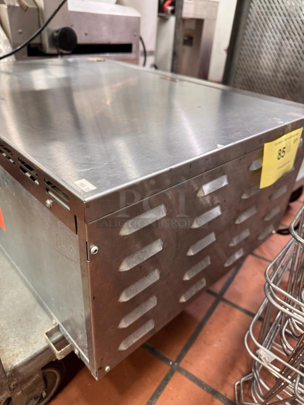 Sodir PZ430S countertop pizza oven, stainless steel, 120V, used condition, vented sides, auction tag visible.