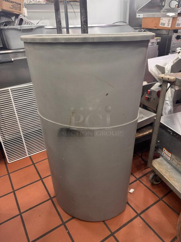Lot of 2 gray cylindrical trash bins, visible wear and scuffs, commercial use.