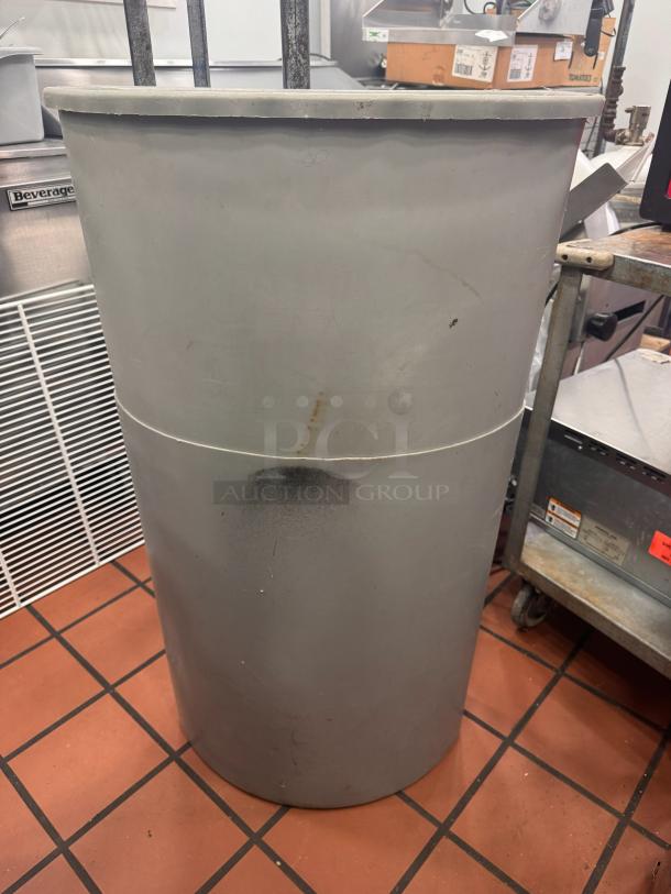 Lot of 2 gray trash bins, used. Visible wear with scratches and marks. Suitable for commercial or industrial use.
