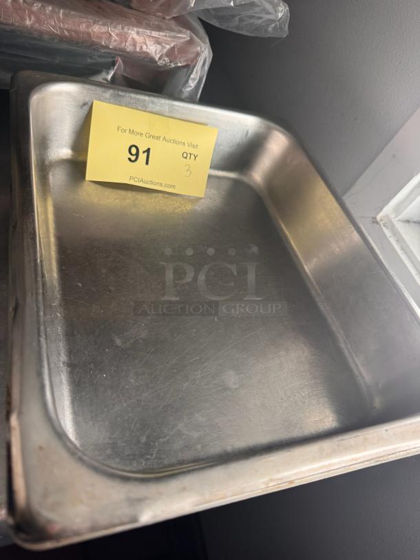 Stainless steel food pan BIDX3; rectangular, gently used condition, auction tag with number 91 visible on the side.