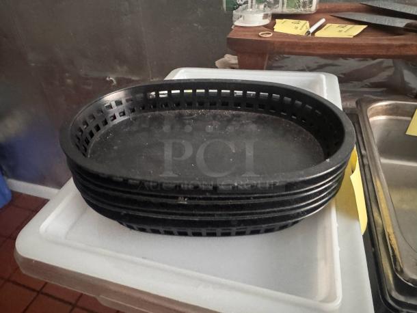 Lot of 6 black oval food baskets, lightly used, stackable design, ideal for serving.
