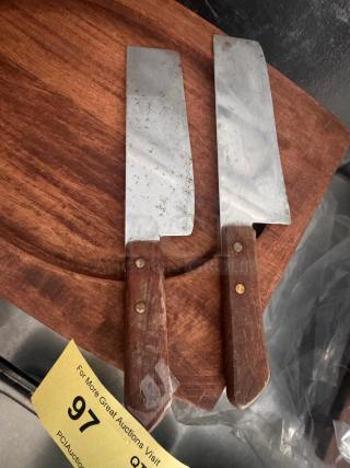 Lot of 2 vintage cleaver knives with wooden handles; visible wear on blades. Auction tag number 97 included.