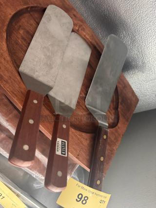 Lot of 3 stainless steel spatulas with wooden handles. Marked "Allied Taiwan." Used condition. Auction tag reads "QTY 98."