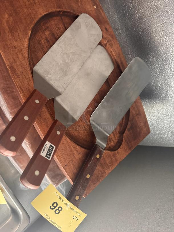 Lot of 3 stainless steel spatulas with wooden handles, used condition. One labeled “Ateco.” Auction tag number 98.