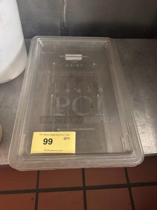 Clear plastic food storage container with lid, in good condition. Markings on lid indicate capacity. Auction lot 99 label visible.